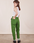 Angled back view of Petite Pencil Pants in Lawn Green on Hana