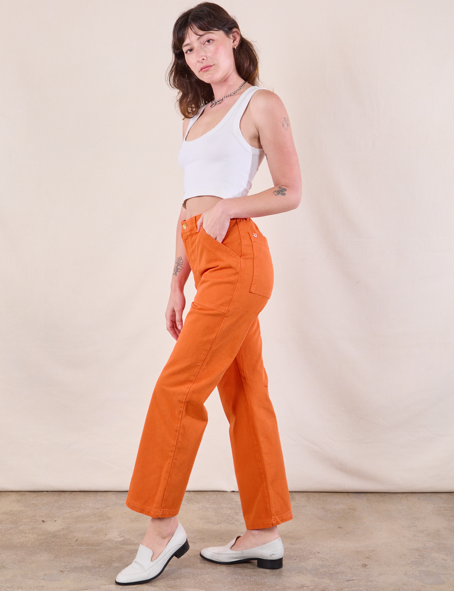 Side view of Work Pants in Construction Orange and Cropped Tank in Vintage Tee Off-White on Alex