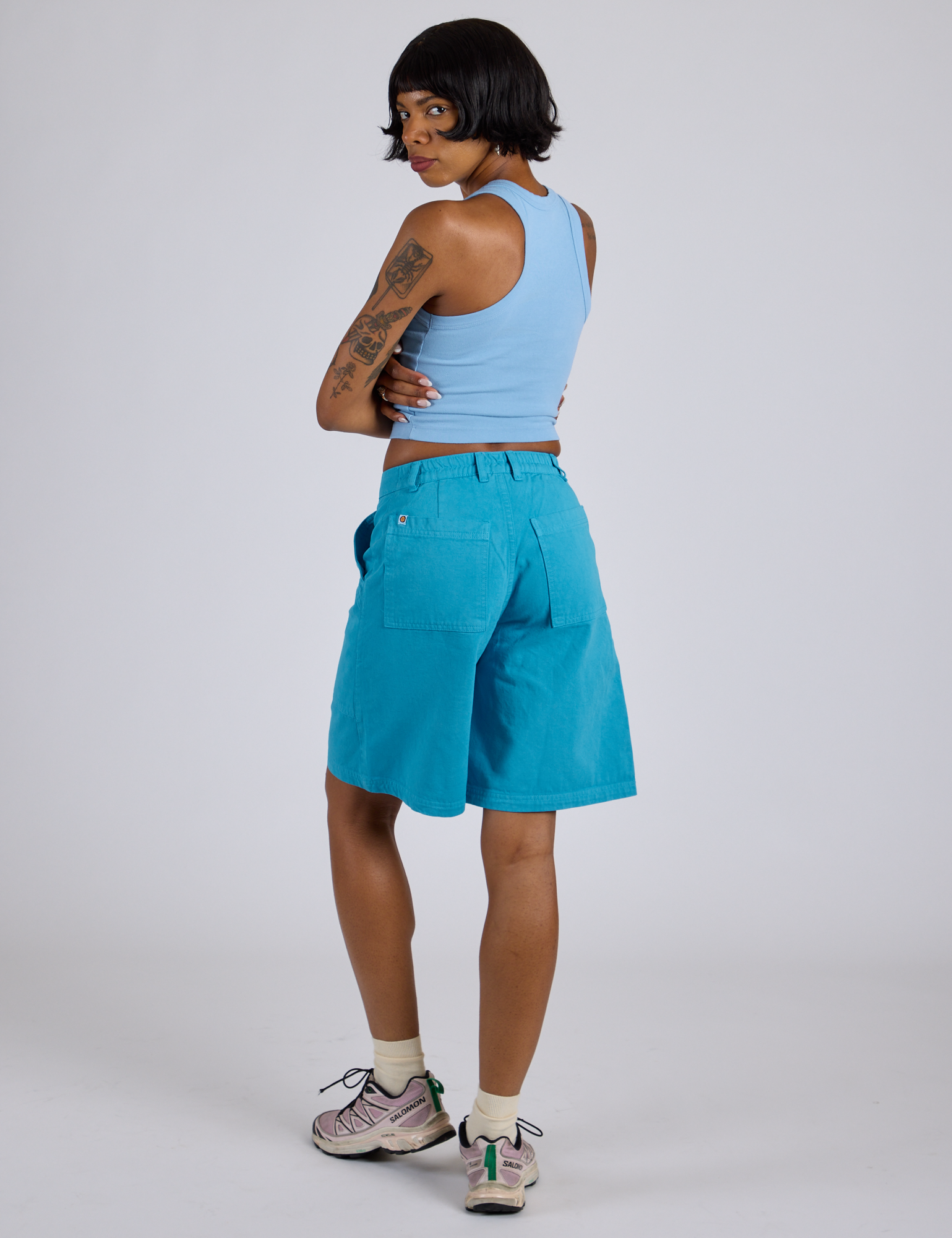 Angled back view of Longline Work Shorts in Hawaiian Blue and baby blue Racerback Tank