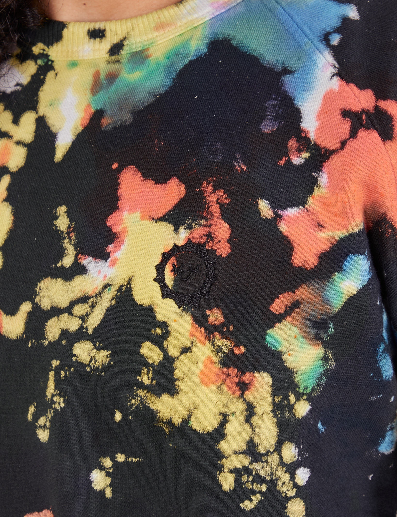 Rainbow Magic Waters Crew close up. Sun baby logo embroidered with black thread