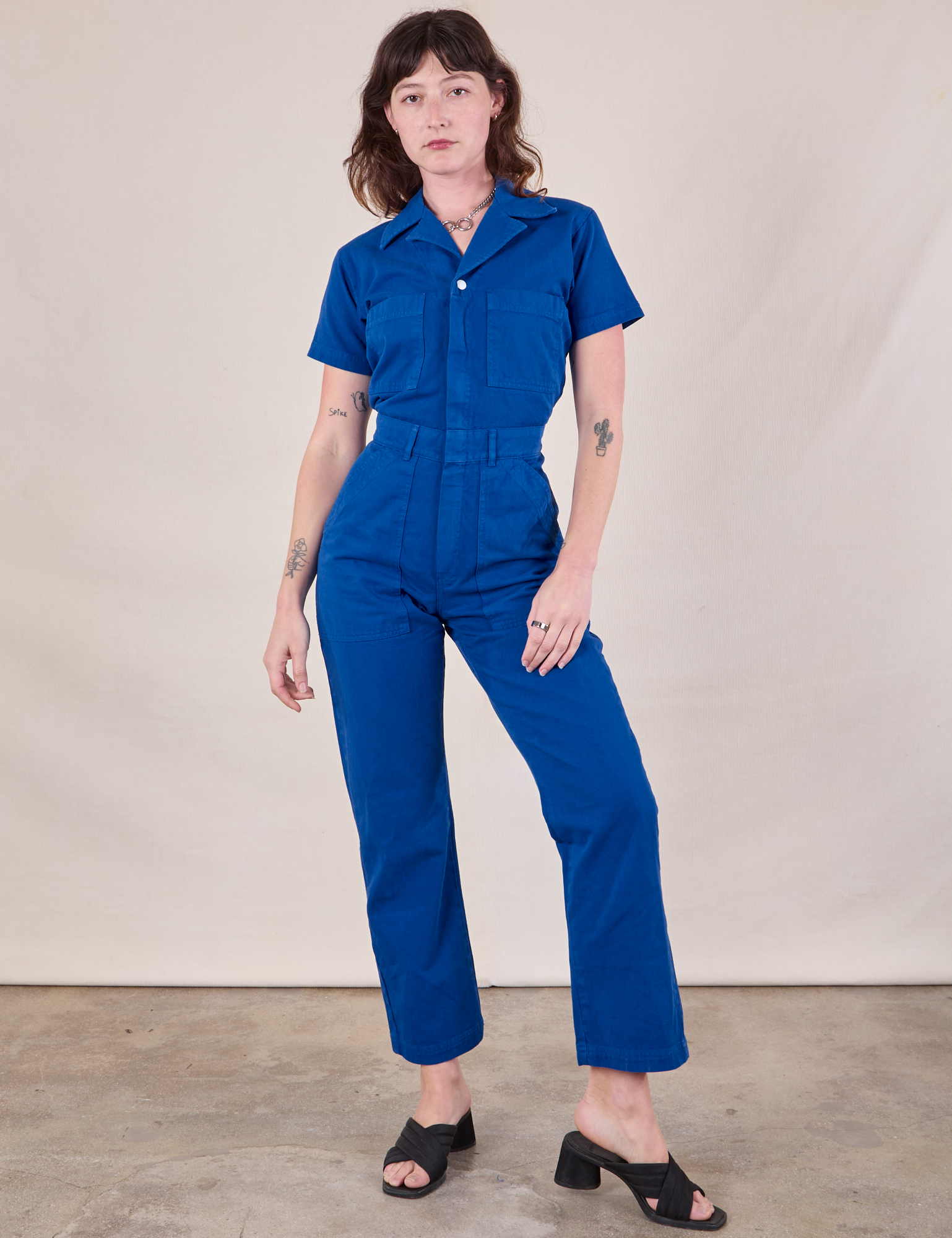 Alex is 5&#39;8&quot; and wearing XS Short Sleeve Jumpsuit in Royal Blue