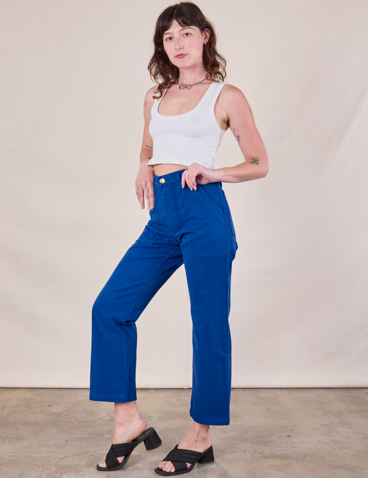 Angled front view of Work Pants in Royal Blue and Cropped Tank in vintage tee off-white