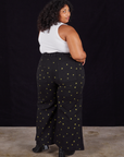 Back view of Star Bell Bottoms in Black and Cropped Tank in vintage tee off-white on Morgan