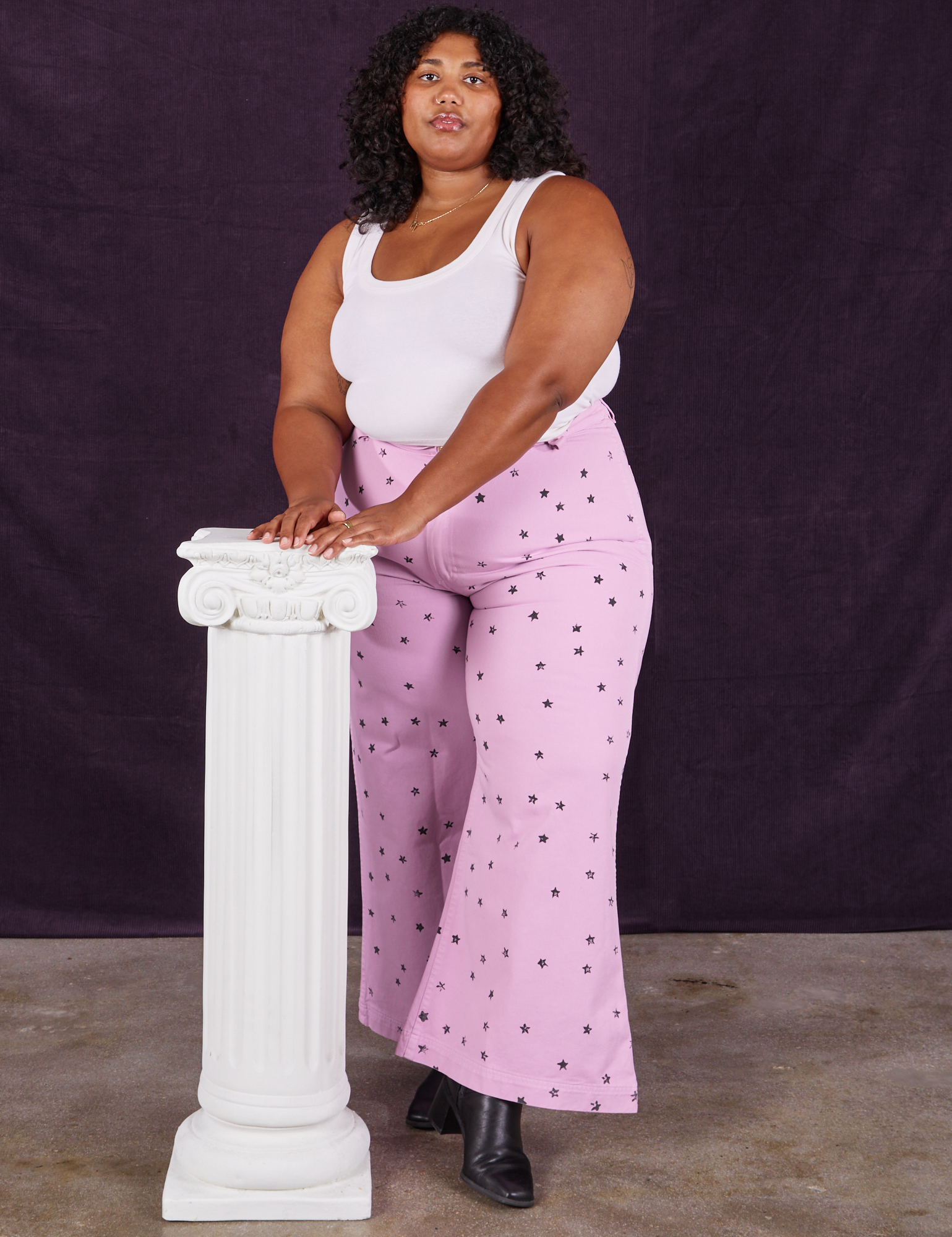 Morgan is wearing Star Bell Bottoms in Lilac Purple and Cropped Tank in vintage tee off-white