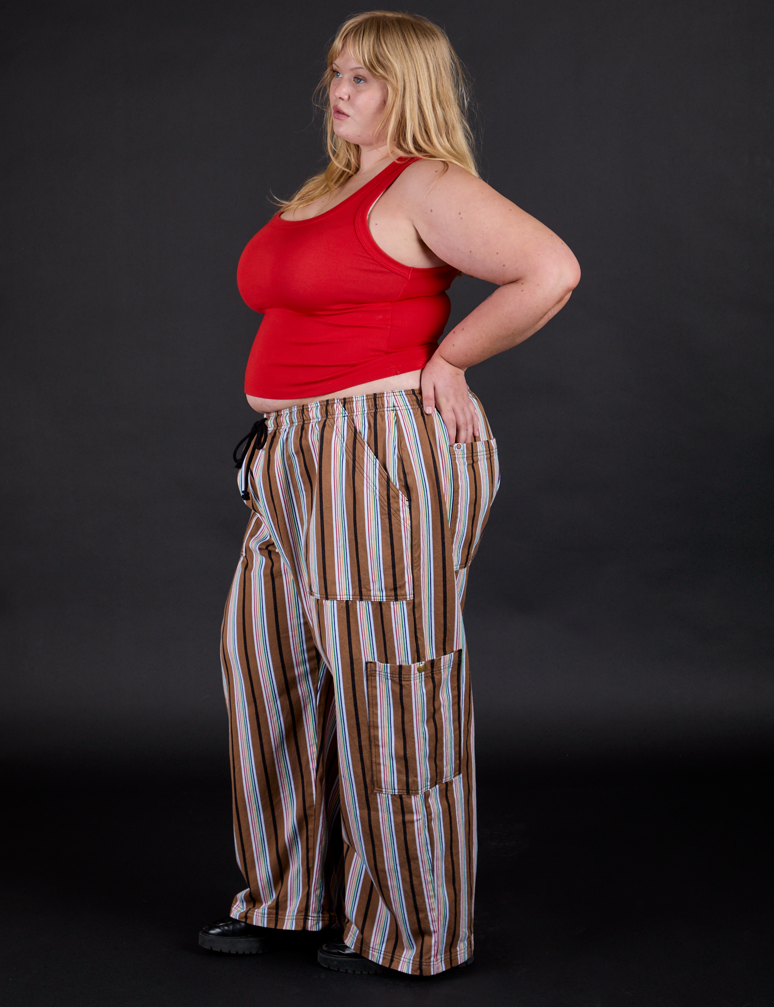 Side view of Striped Drop Pocket Pants in Retro Rainbow and mustang red Tank Top