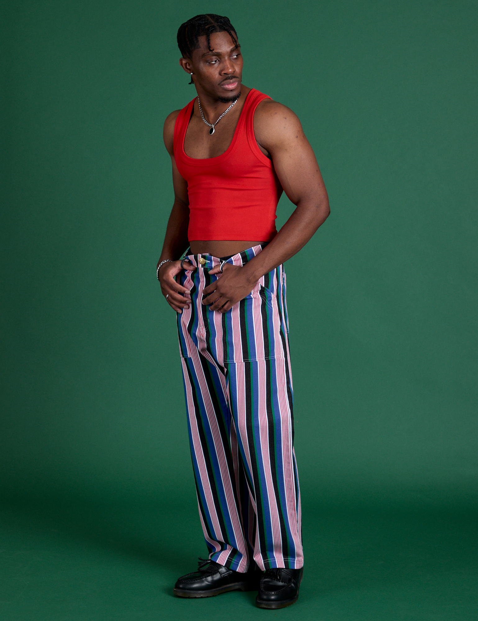 Angled front view of Work Pants in Pacific Stripe and mustang red Cropped Tank on Isaac