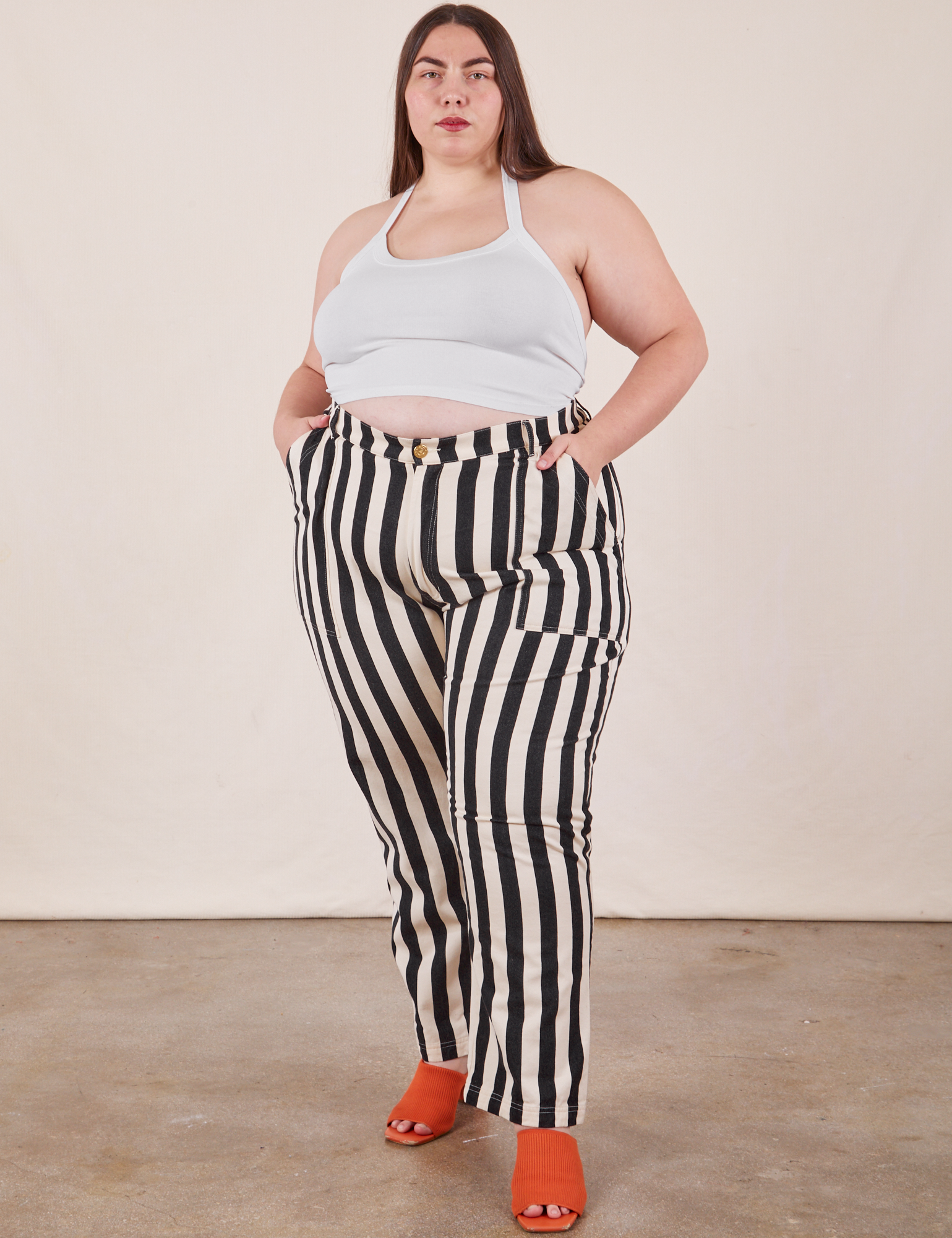 Marielena is 5&#39;8&quot; and wearing 2XL Black Striped Work Pants in White paired with vintage off-white Halter Top