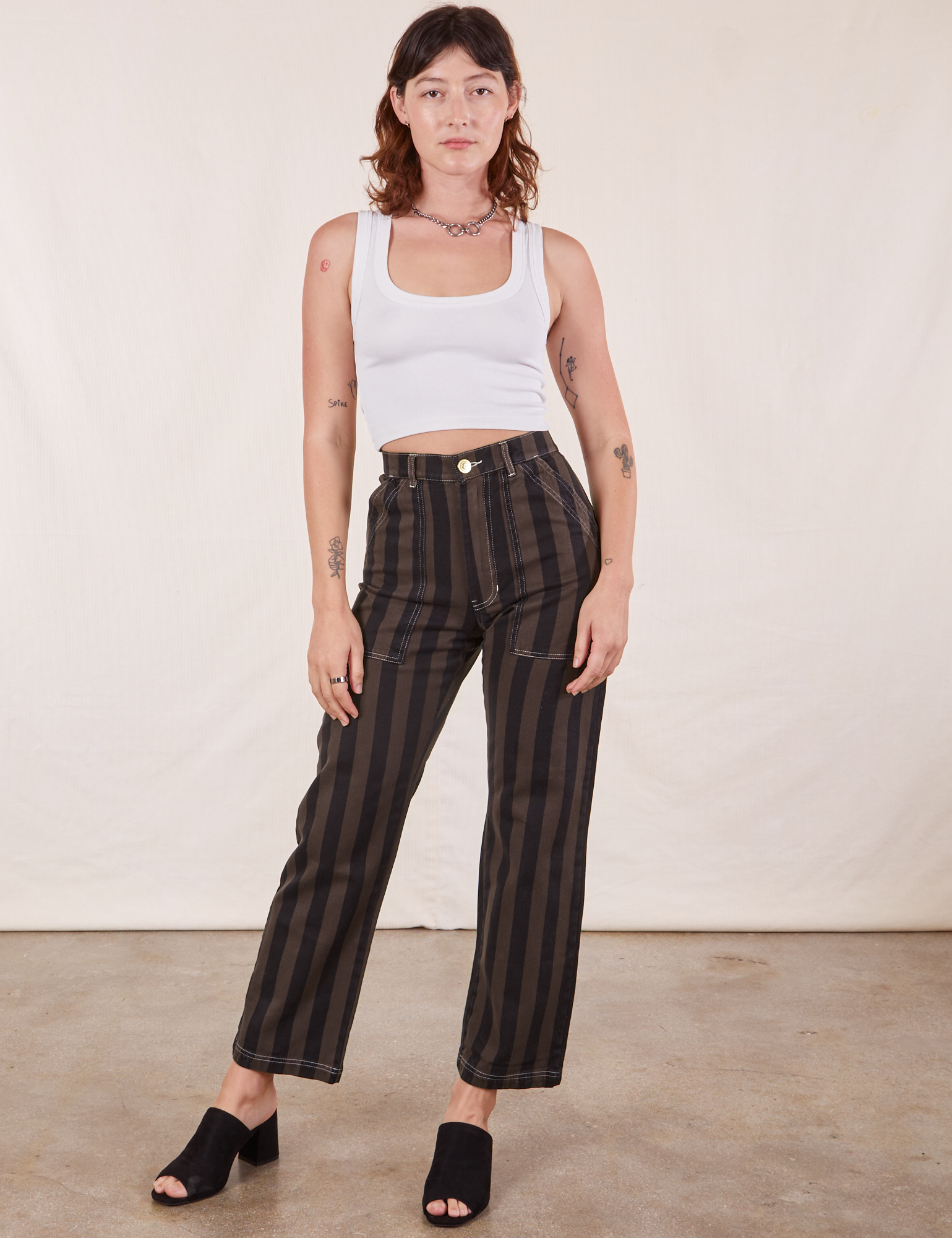 Alex is wearing Black Striped Work Pants in Espresso and vintage off-white Tank Top