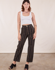 Alex is wearing Black Striped Work Pants in Espresso and vintage off-white Tank Top