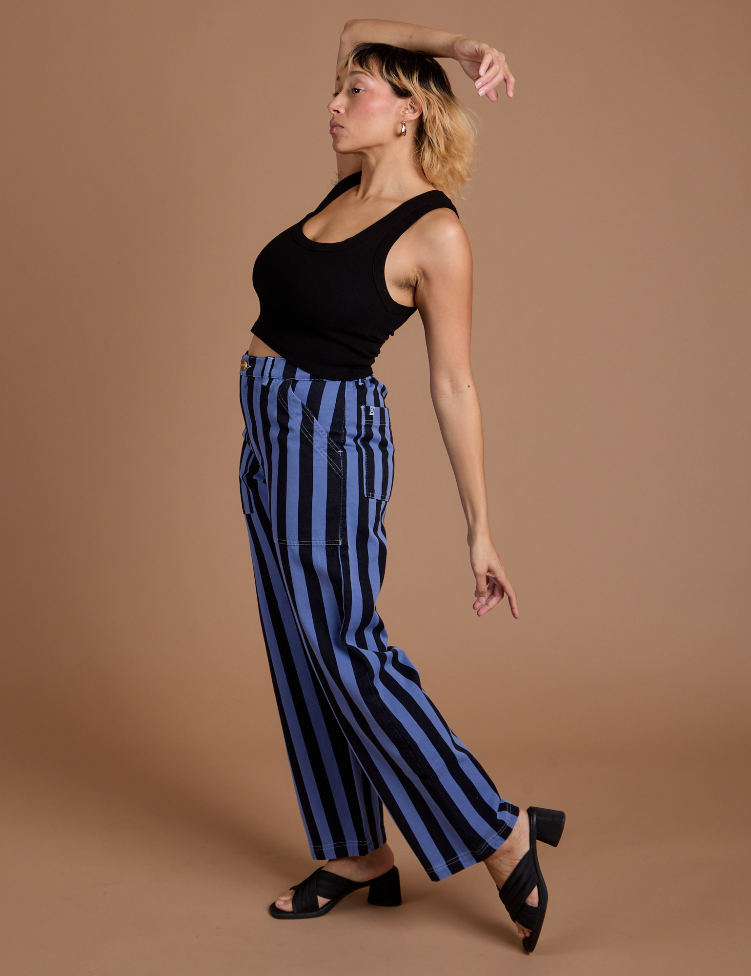 Side view of Black Stripe Work Pants in Cornflower Blue and black Cropped Tank on Tiara