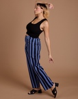 Side view of Black Stripe Work Pants in Cornflower Blue and black Cropped Tank on Tiara