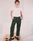 Quinn is 6'4" and wearing M Carpenter Jeans in Swamp Green paired with a Organic Vintage Tee in Vintage Tee Off-White