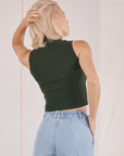Sleeveless Essential Turtleneck in Swamp Green back view on Madeline