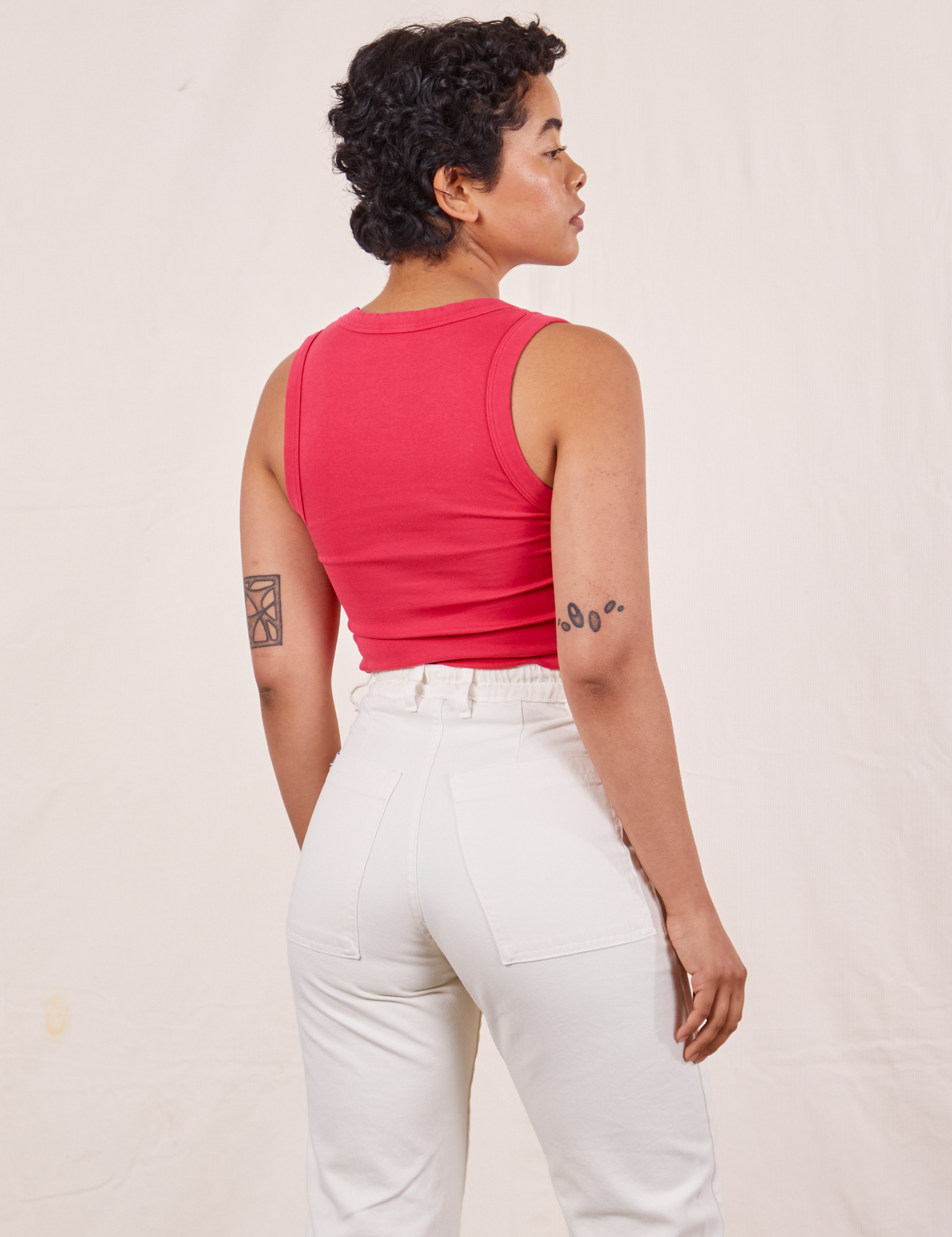 Back view of Tank Top in Hot Pink and vintage off-white Western Pants on Mika