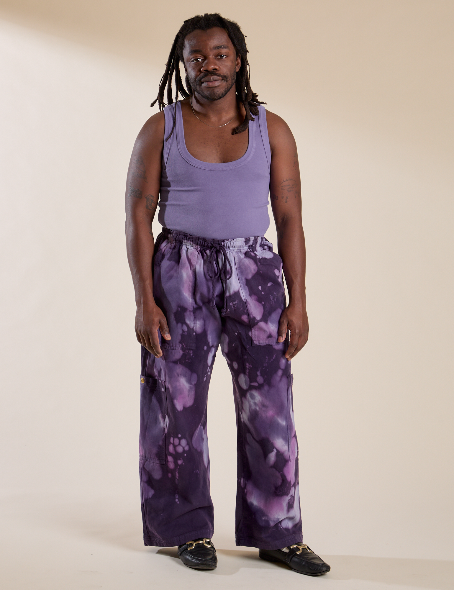 Demi is 5'6" and wearing S Magic Waters Drop Pocket Pants in Dark Lavender paired with faded grape Cropped Tank