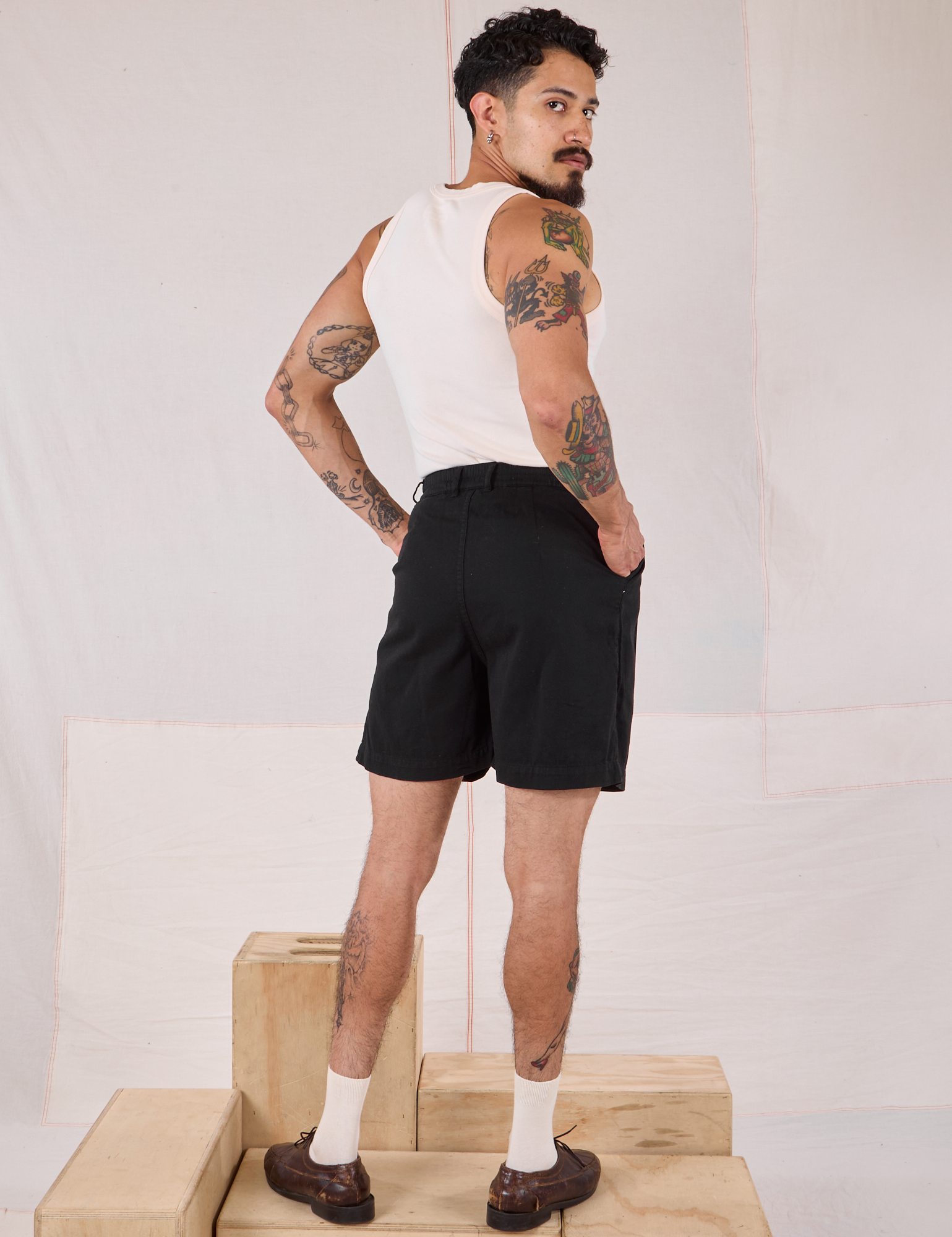Back view of Trouser Shorts in Basic Black and Tank Top in vintage tee off-white on Jesse