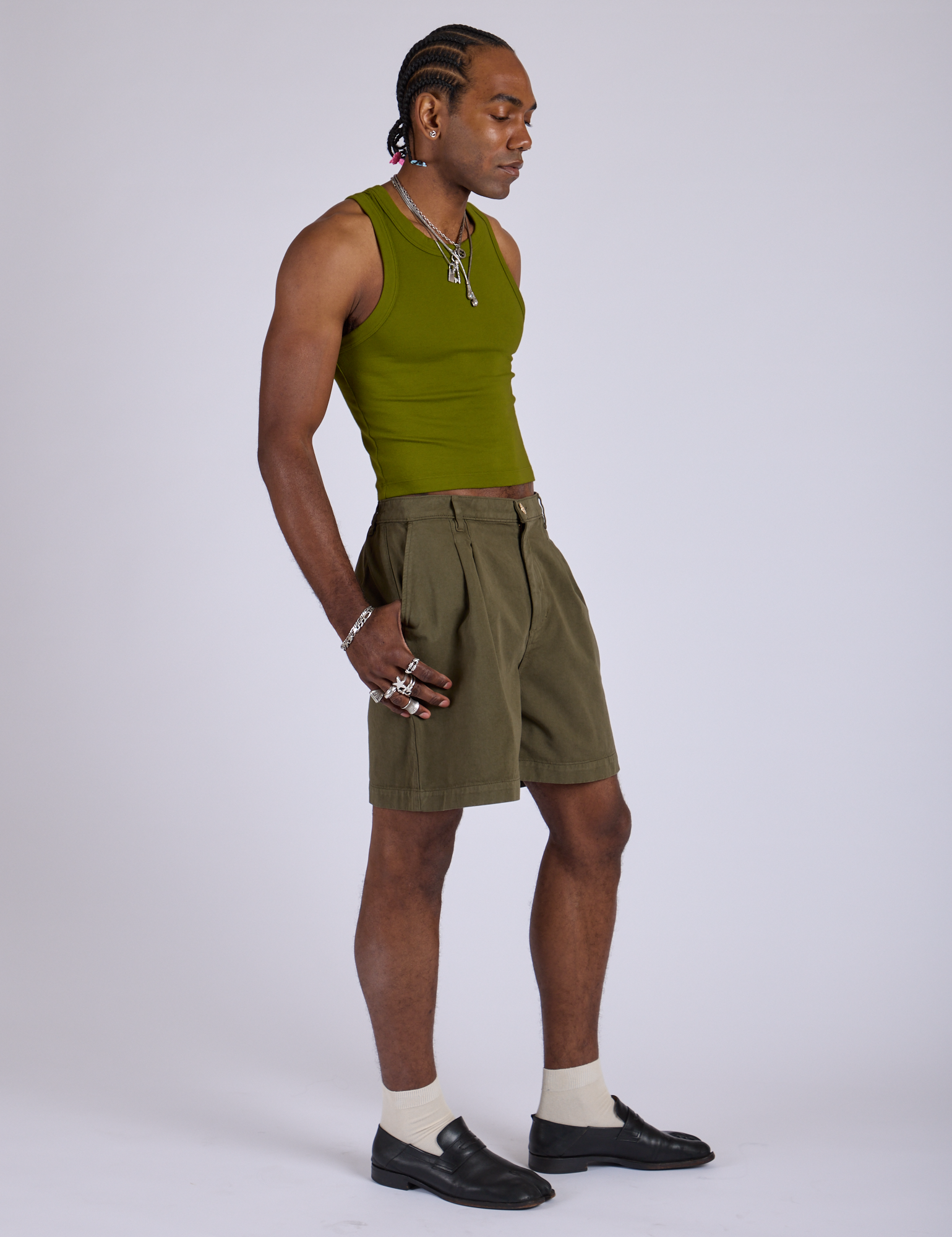 Side view of Pleated Trouser Shorts in Surplus Green and summer olive Racerback Tank