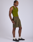 Side view of Pleated Trouser Shorts in Surplus Green and summer olive Racerback Tank