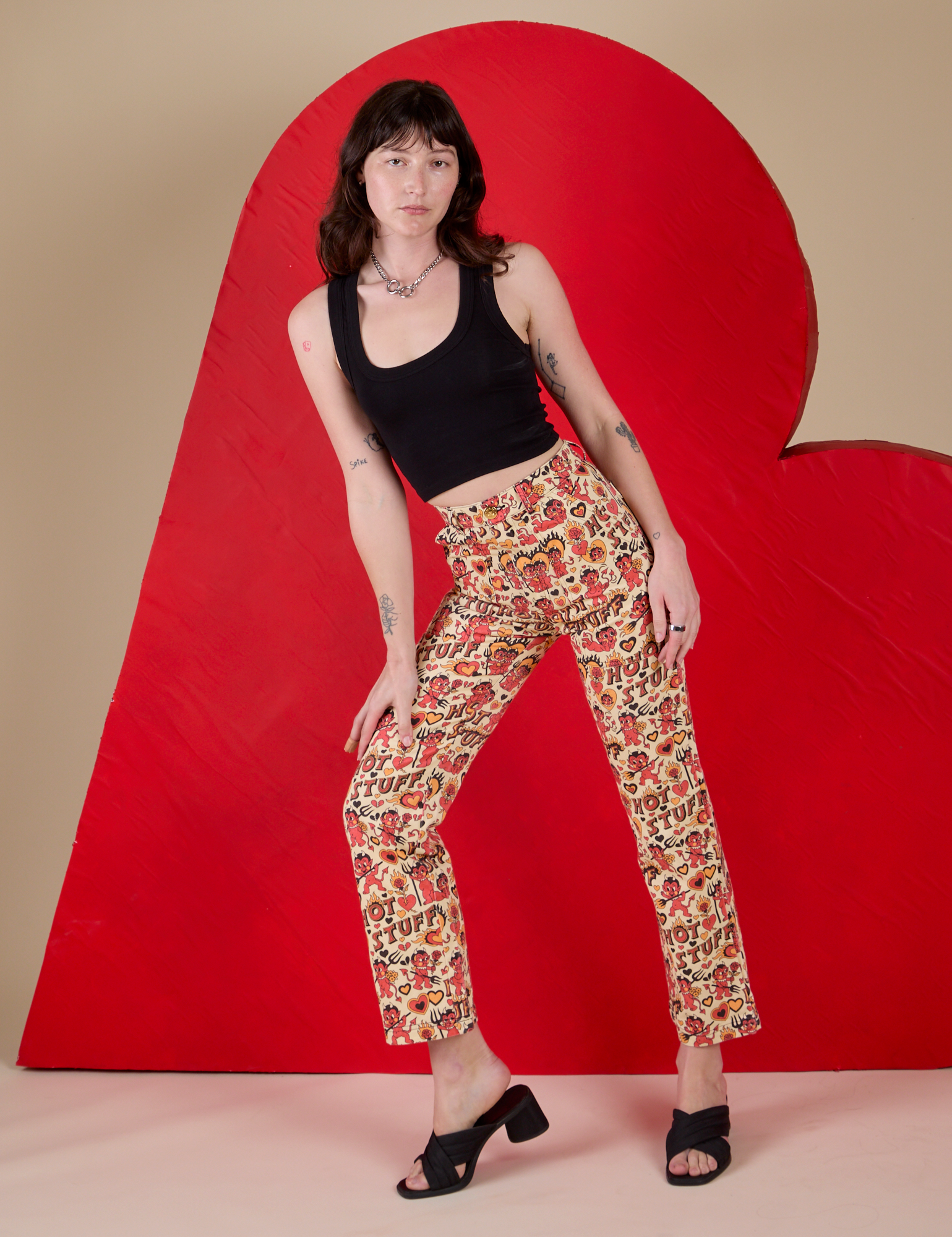 Alex is 5’8” and wearing XXS Work Pants in Hot Stuff Print paired with a black Cropped Tank