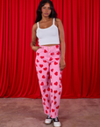 Kandia is 5'3" and wearing XS Paintstamped Heart Work Pants in Bubblegum Pink paired with a Cami in vintage tee off-white