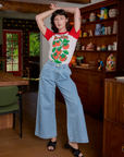 Alex is wearing Short Sleeve Raglan Tee in Tomatoes tucked into light wash Indigo Wide Leg Trousers
