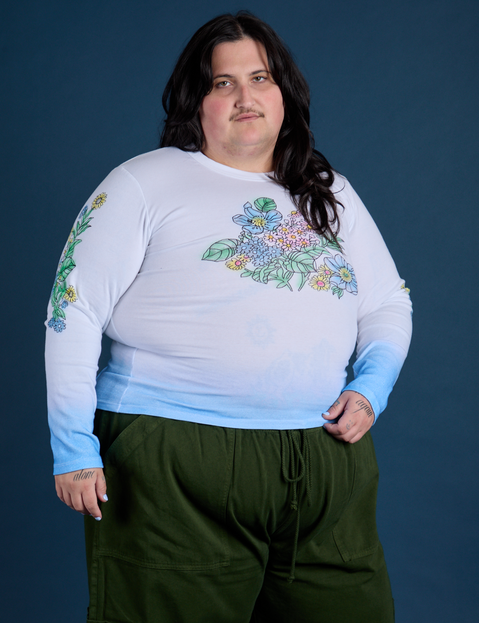 Angled front view of Floral Long Sleeve Baby Tee in Baby Blue on Sam