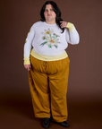 Sam is wearing Floral Long Sleeve Baby Tee in Yellow and spicy mustard Drop Pocket Cargo Pants