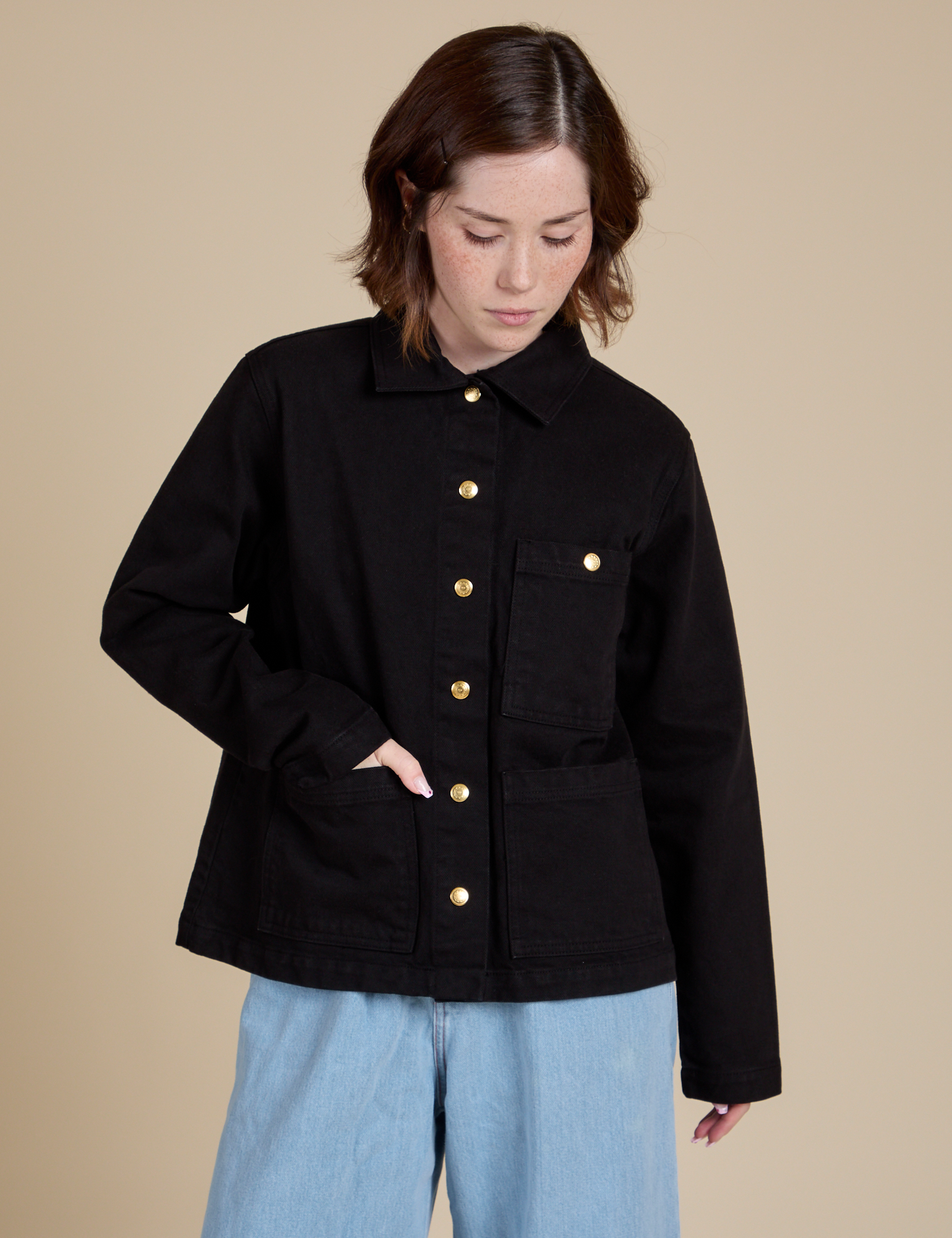 Hana is wearing a buttoned up Work Jacket in Basic Black
