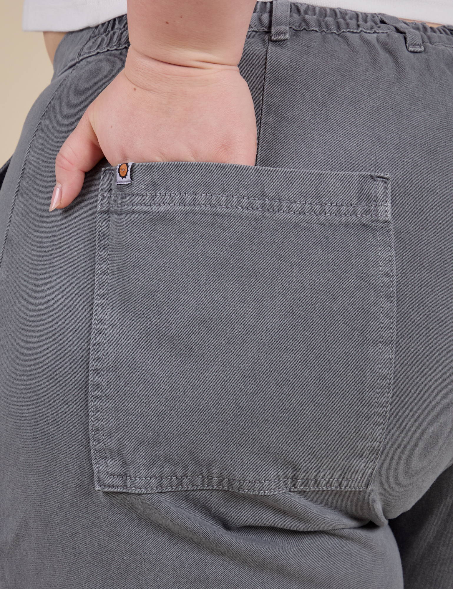 Close up of Ashley's hand in the back pocket of Work Pants in Washed Grey