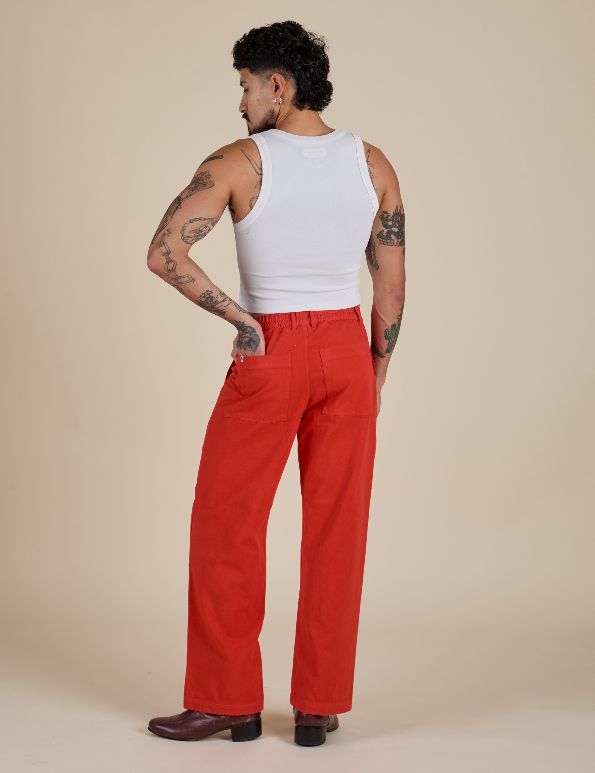Back view of Work Pants in Mustang Red and Cropped Tank in Vintage Tee White on Jesse