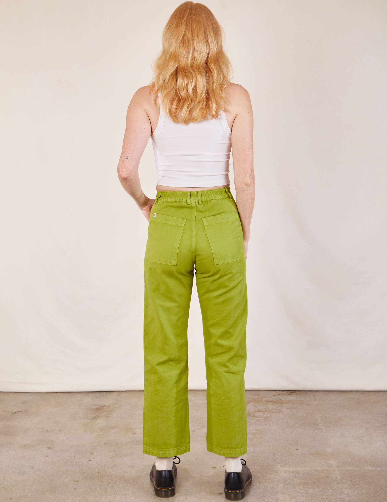 Back view of Work Pants in Gross Green and Cropped Tank in vintage tee off-white on Margaret