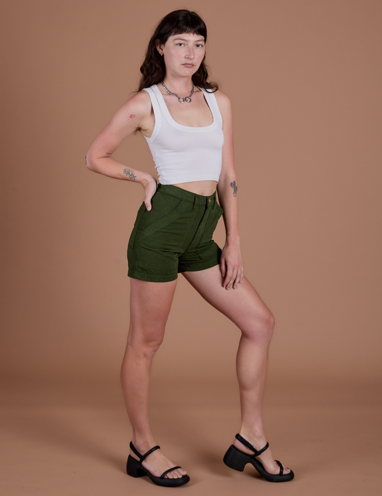 Angled front view of Classic Work Shorts in Evergreen and Cropped Tank in Vintage Tee White on Alex