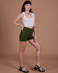 Angled front view of Classic Work Shorts in Evergreen and Cropped Tank in Vintage Tee White on Alex