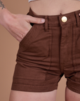 Close up of Alex's hand in the front pocket of Classic Work Shorts in Fudgesicle Brown