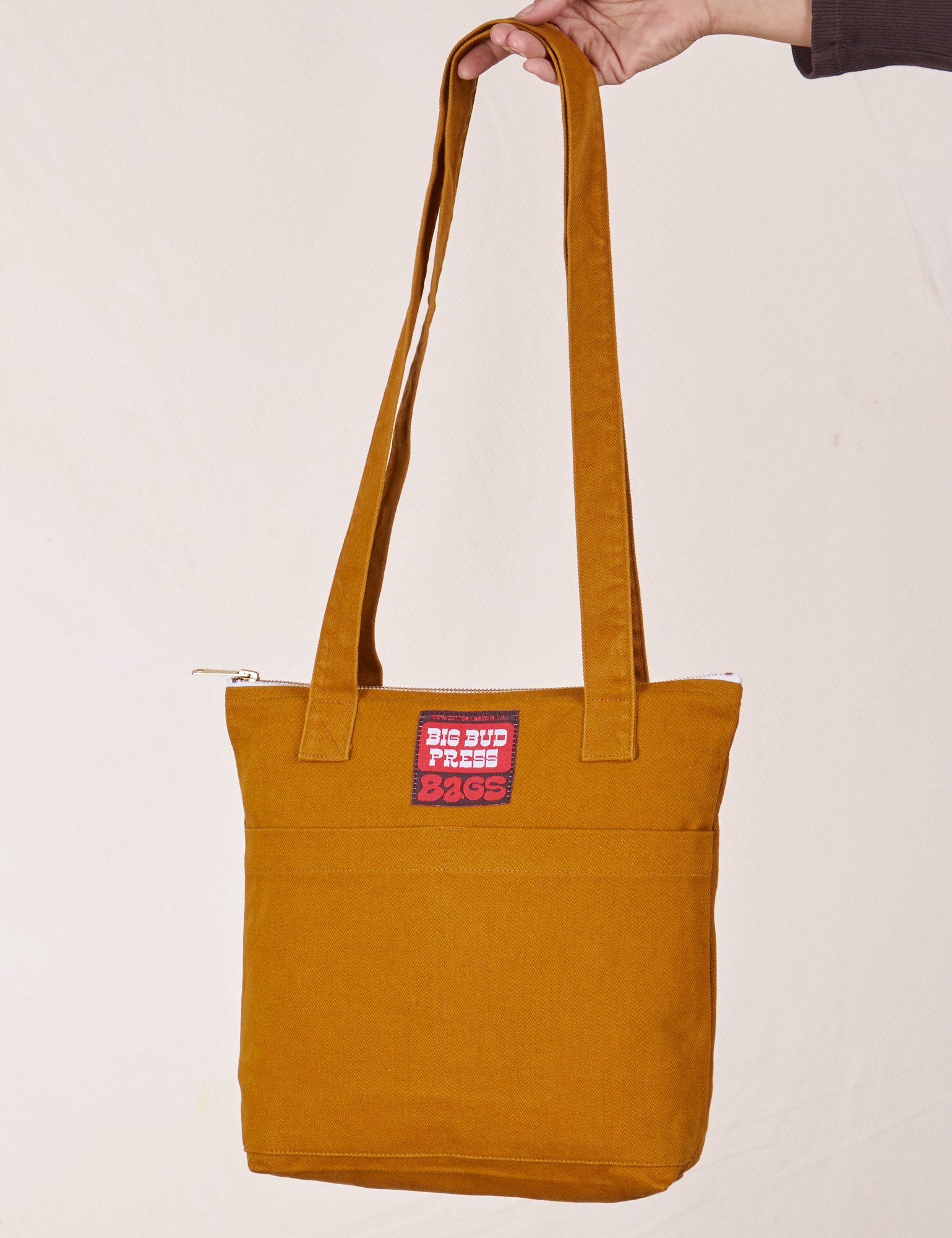 Over-Shoulder Zip Mini Tote in Spicy Mustard held by model