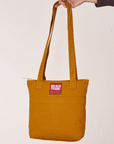 Over-Shoulder Zip Mini Tote in Spicy Mustard held by model