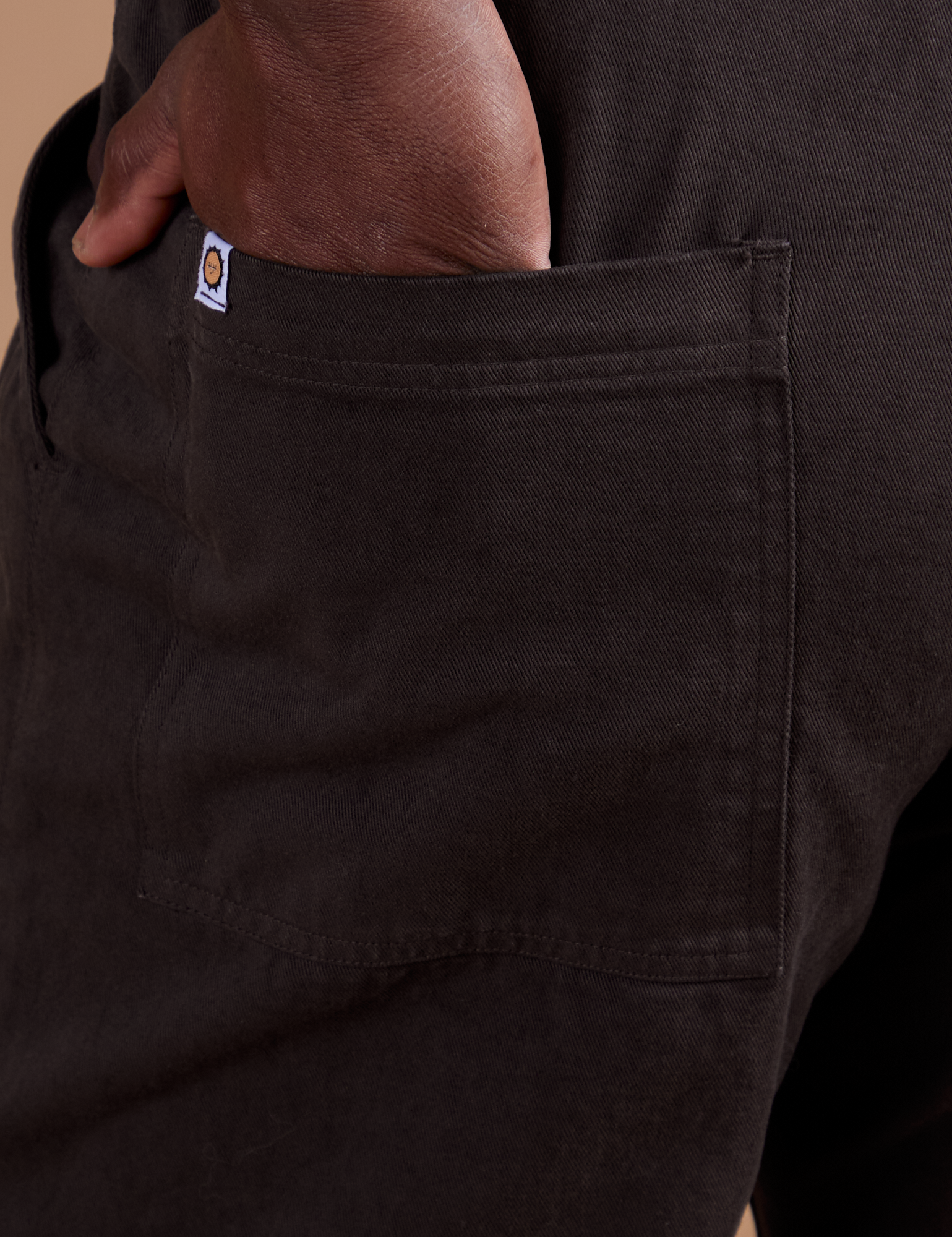 Close up of Demi's hand in the back pocket of Work Pants in Espresso Brown