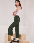 Side view of Action Pants in Swamp Green and Cropped Tank in vintage tee off-white on Alex