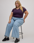 Baby Tee in Nebula Purple and light wash wide leg trousers on Juliet