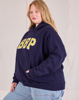 Collegiate Hoodie in Navy Blue side view on Juliet