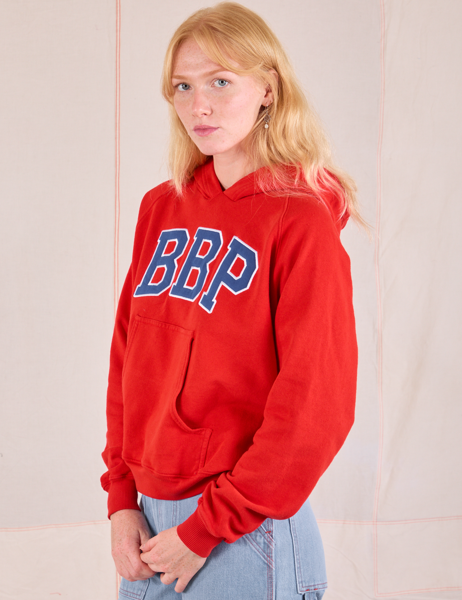 Collegiate Hoodie in Mustang Red angled front view on Margaret