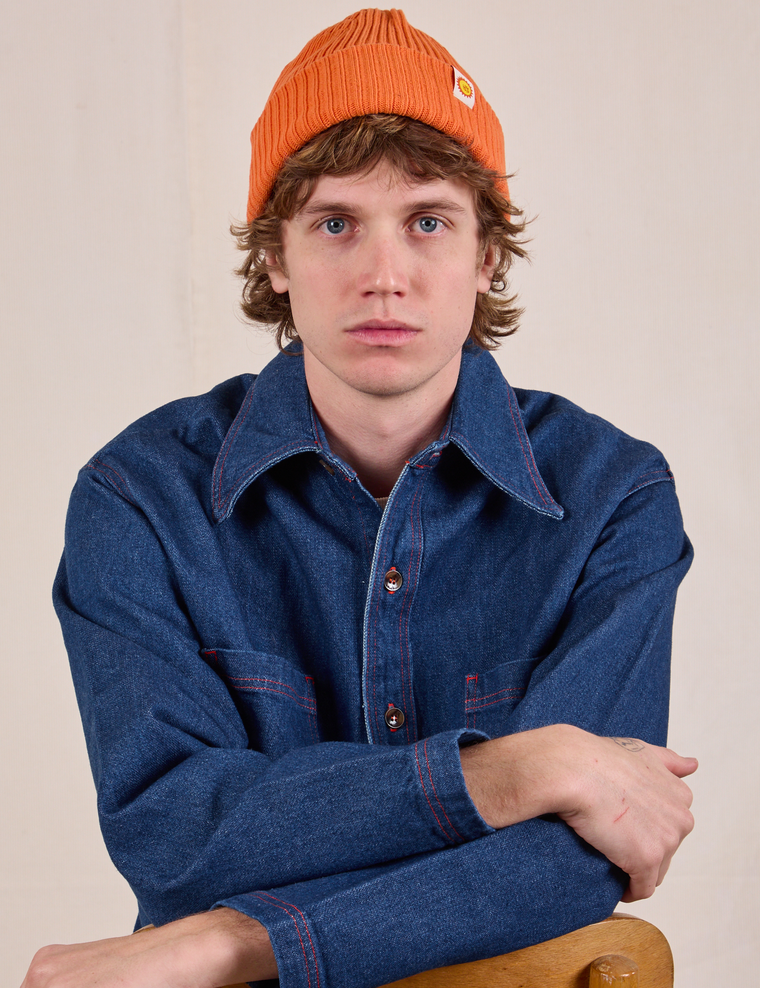 Quinn is wearing Ribbed Beanie in Construction Orange