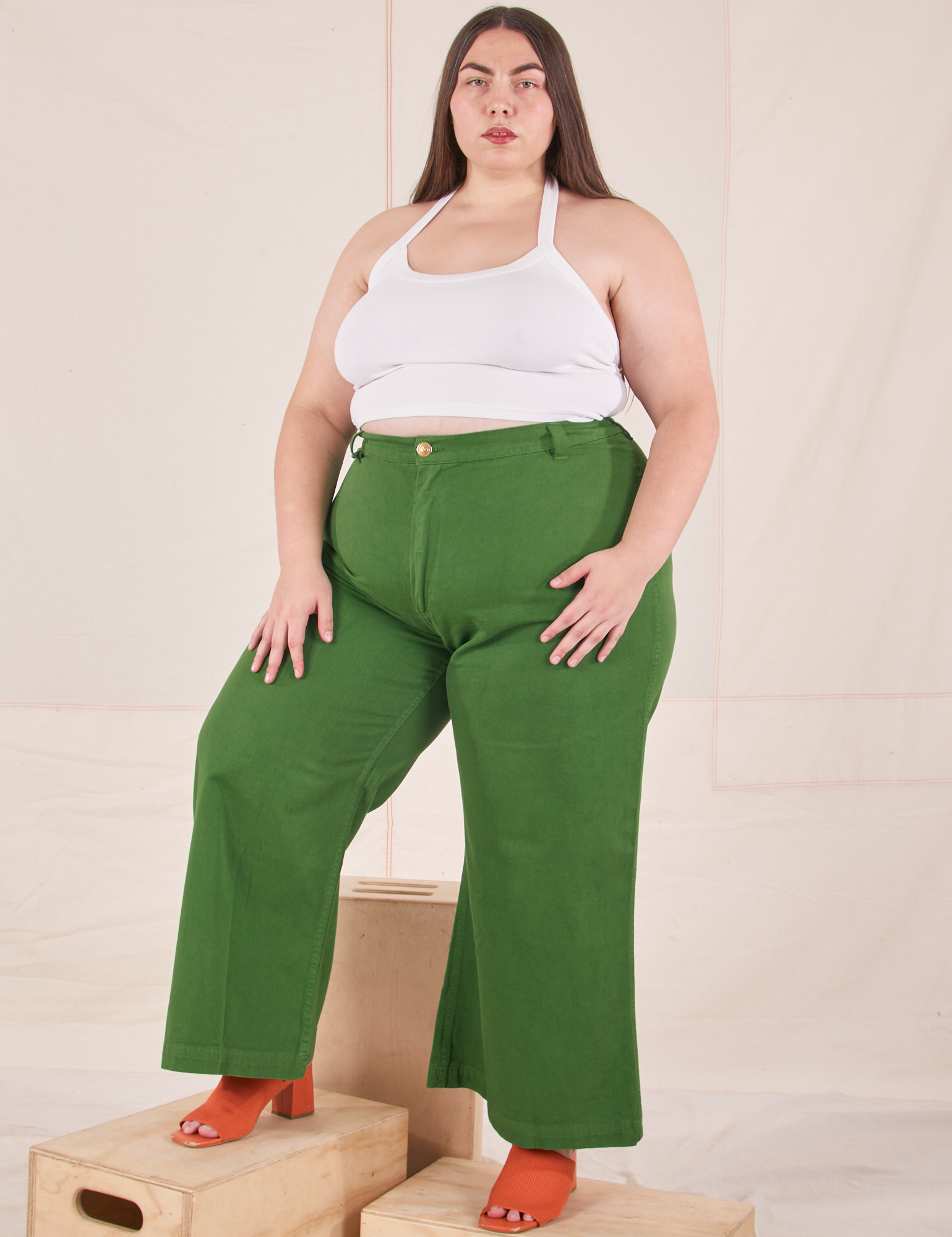 Marielena is 5&#39;8&quot; and wearing 2XL Bell Bottoms in Lawn Green paired with vintage off-white Halter Top