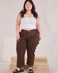 Ashley is 5'7" and wearing 1XL Petite Overdyed Carpenter Jeans in Fudge paired with Cropped Tank in vintage tee off-white