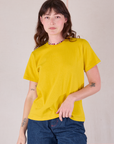 Alex is 5'8" and wearing P Burly Tee in Golden Yellow