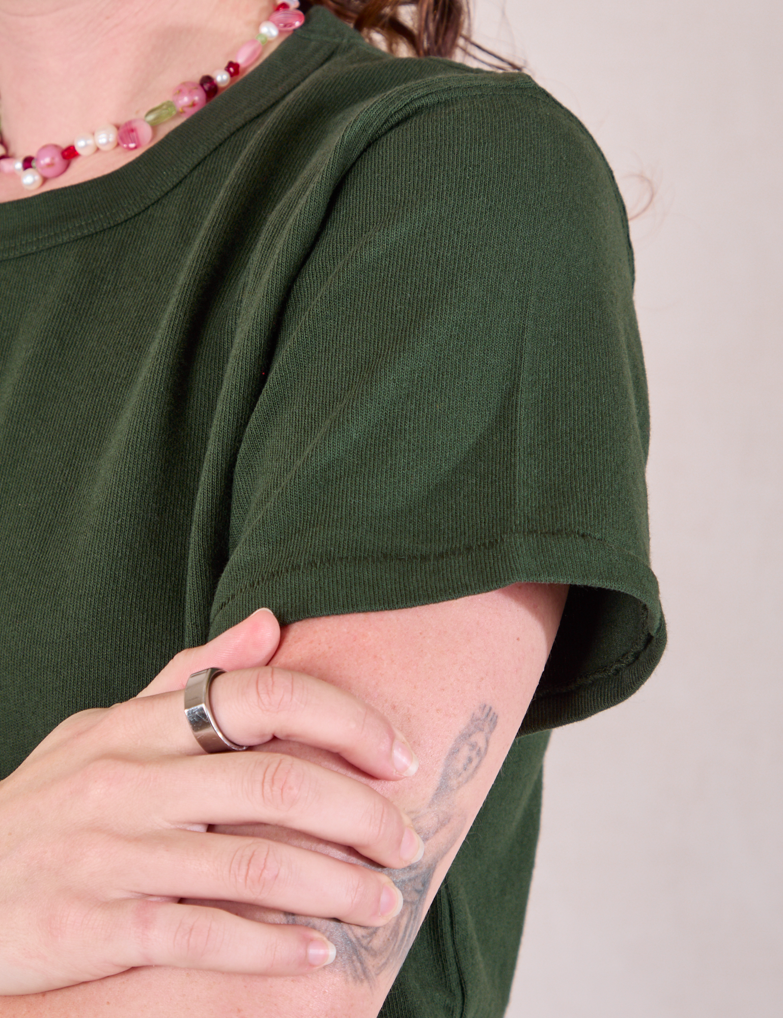 Burly Tee in Swamp Green sleeve close up on Alex