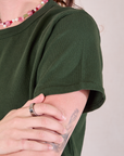 Burly Tee in Swamp Green sleeve close up on Alex