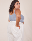 Angled back view of Cropped Cami in Periwinkle and vintage off-white Western Pants worn by Alicia