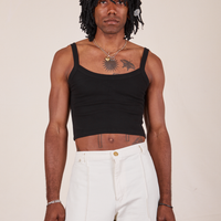 Jerrod is wearing S Cropped Cami in Basic Black paired with vintage off-white Western Pants