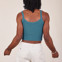 Back view of Cropped Cami in Marine Blue and vintage off-white Western Pants worn by Jerrod